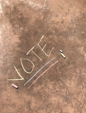 Vote written on the pavement with chalk
