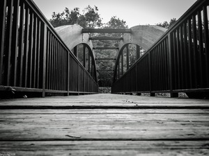 Quiet wooden bridge photographs in black-and-white