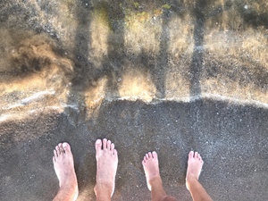 Father and son feet in the beach