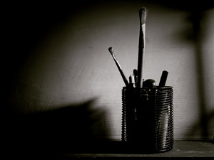 pen stand with pens and brushes in it
