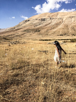 Girl on a dry country field in summer