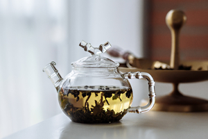 Glass teapot with green tea