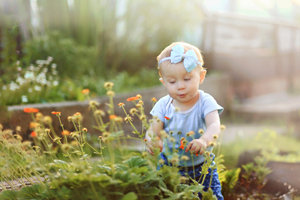Baby girl in summer garden