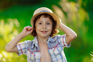 Curly boy with hat in Summer