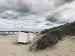 Beach huts on cloudy day