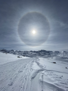 Sun in a halo on the snowy mountain