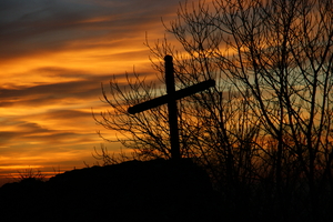 A cross at the Gügel Church at sunrise