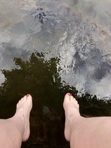 feet dangling over water