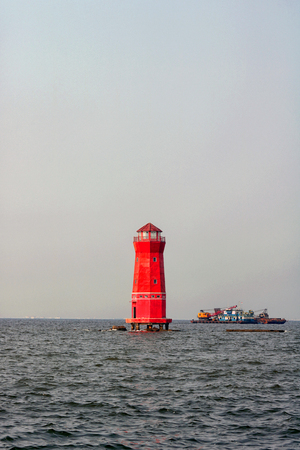 Red lighthouse offshore
