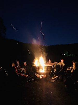 Froiends sitting around campfire