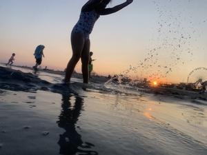 Playing on the beach at sunset