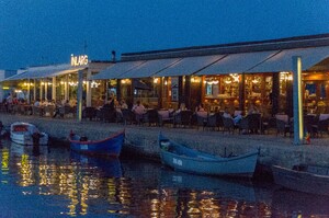 Restaurant in small harbour at night