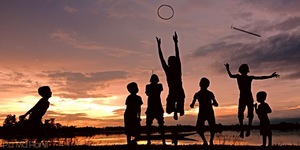 Children playing at sunset