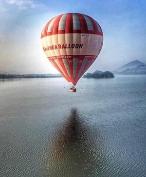 Hot air balloon above lake