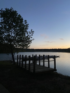 Pier at a lake during sunset