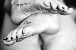 Close up of feet with tattoo