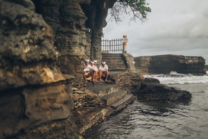 Local people sitting on stairs alongside sea