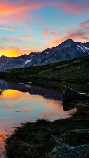 Lake at sunset and snow covered mountains in background