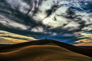 Scenic view of desert landscape against dramatic sky