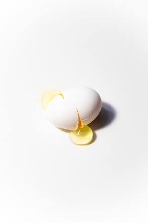 Boken egg on yellow background