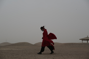 Man in red coat walking China gansu Su Huang