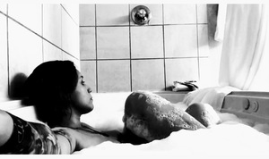 woman taking a bath b/w