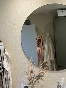 Woman taking selfie in bathroom