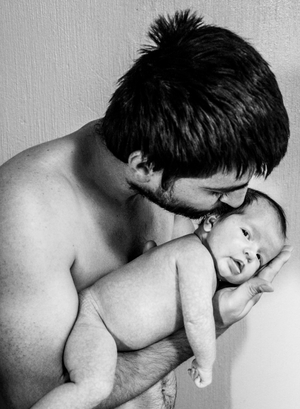 Father holding baby in arms black & white