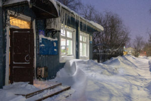 Wooden house during winter covered in snow