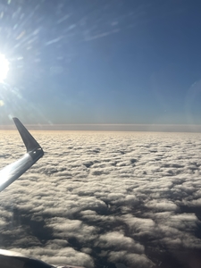 Wing of aircraft above the clouds