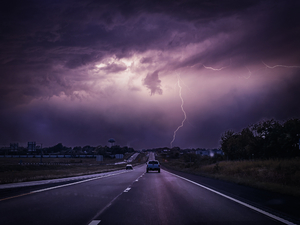 car driving through lightening storm