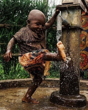 Young boy playing with fresh water