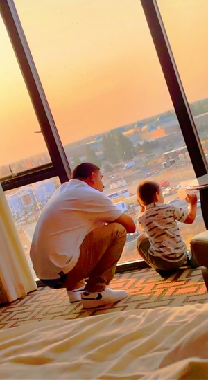 father son looking out of the window