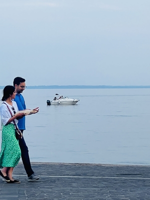 Couple walking alongside of Lake Garda Verona Italy