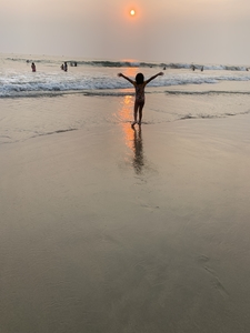 Child on the beach at sunset