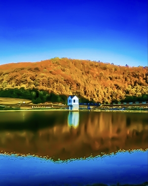 House alongside the lake in autumn