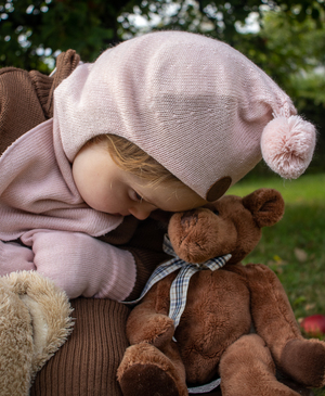 Little girl and teddybear in cart