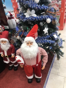 Santa clause in front of christmas tree, decoration