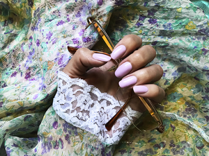 purple manicure on textile background manicure