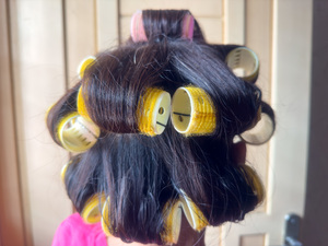 Back view of an asian old lady with hair curlers