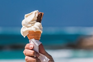 Hand holding melting ice cream